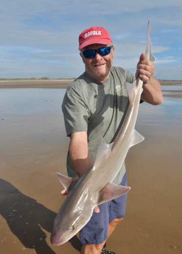 Dave Lewis holding a fish.