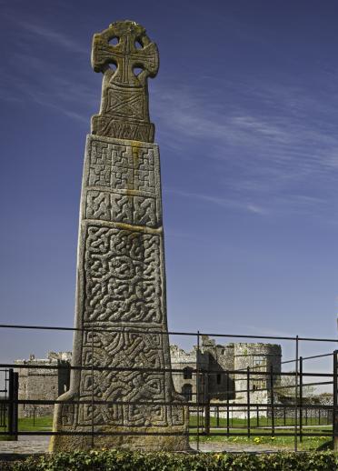 A large stone cross with Celtic patterns engraved on it.