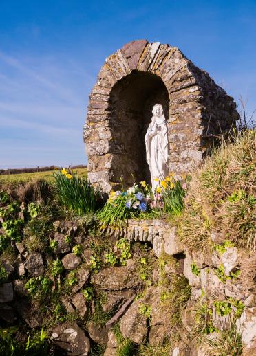 Shrine at St Non's Chapel with daffodils.