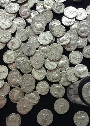 Roman coins scattered on a table