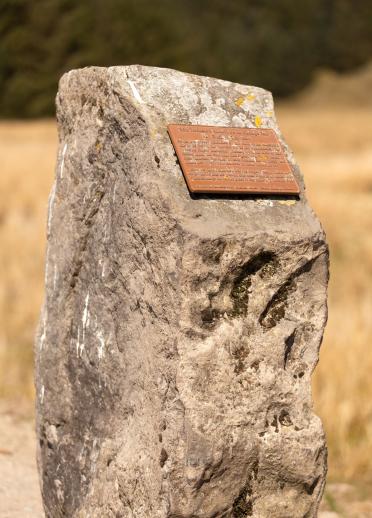 Large stone with a plaque.