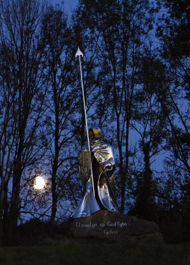 Steel statue in the moonlight.