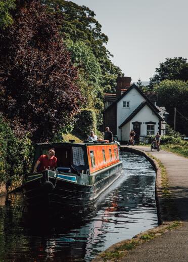 A colourful narrowboat on a canal. 