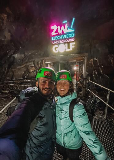 Couple underground playing golf