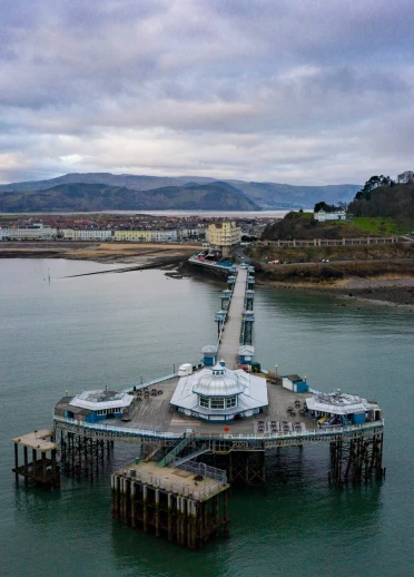 Aerial view of a pier and coastline from out at sea.