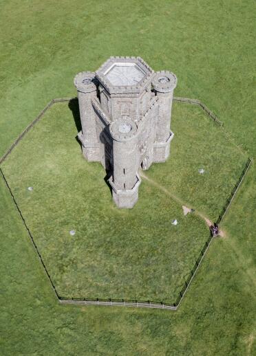 aerial view of tower surrounded by grass.