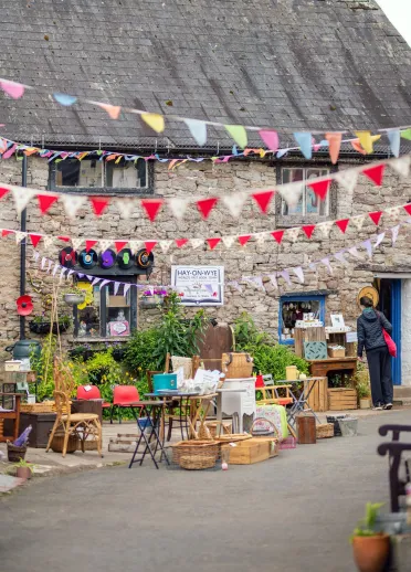 shop with displays outside and colourful bunting.