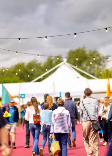 people at festival with tents.