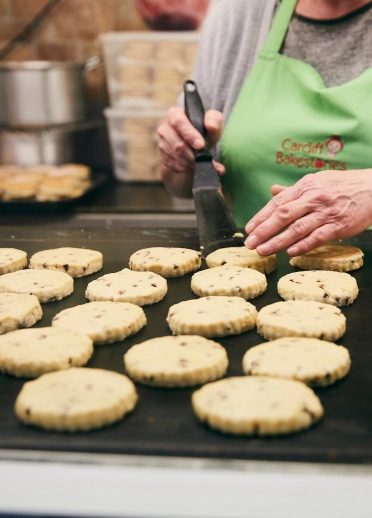 Woman cooking Welsh cakes.