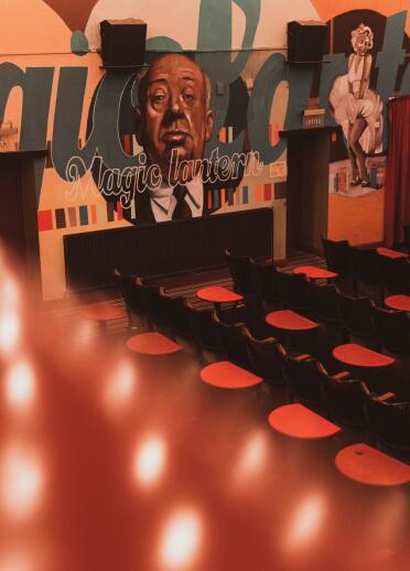 Inside the Magic Lantern cinema with colourful wall art. 