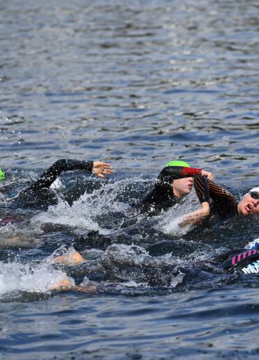 A group of people in a open water swimming race.