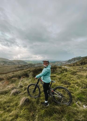 Cyclist on a mountain bike surrounded with Blaenau Ffestiniog in the background