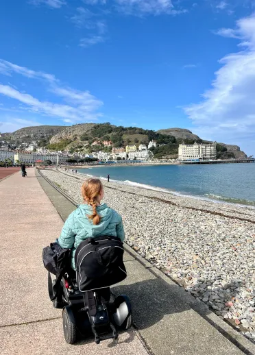 woman in motorised wheelchair on Llandudno Promenade.