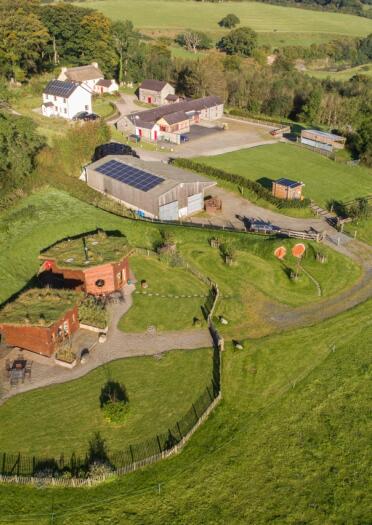 Aerial photo of farmyard and cabins.