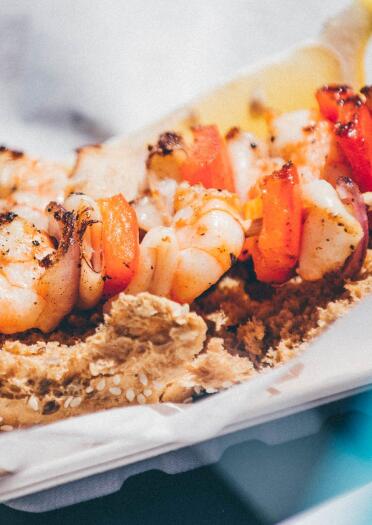 A tasty seafood kebab on a bun served in a tray at Pembrokeshire Fish Week.