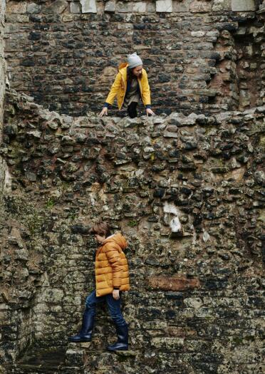 Children exploring the walls inside an ancient castle