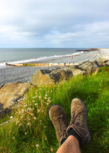 Walker's legs (lying down) Wales Coast Path to the southwest of Aberaeron.
