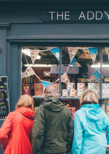two people looking into a book shop window in Hay on Wye.