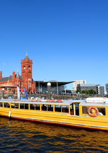 Cardiff Bay water taxi with Pierhead Building and WMC in background.