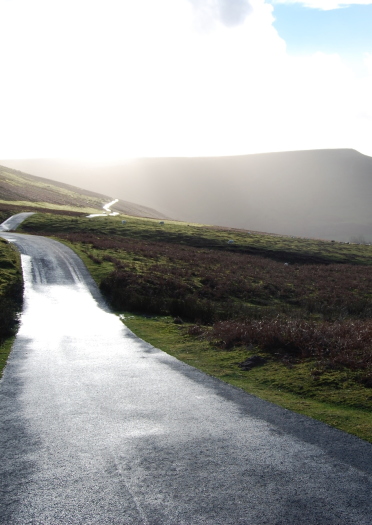 A narrow winding road up a mountainside.