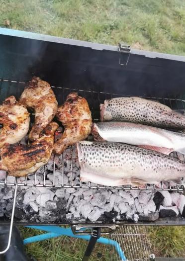Fresh fish on a barbecue and chicken.