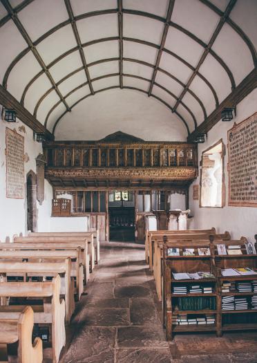 interior or church with a wooden balcony.