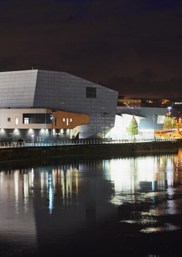 night photo across river to Riverfront Theatre and Arts Centre, Newport.