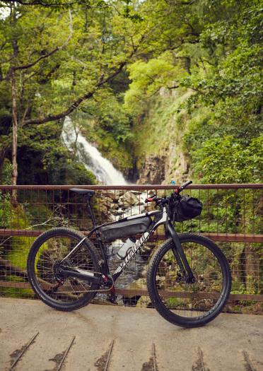 Bike parked up in front of waterfall