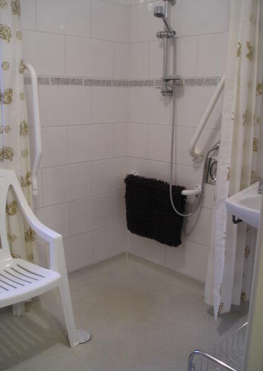 An accessible shower in a wet room.