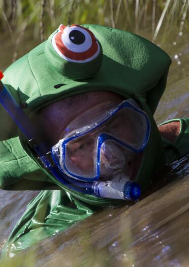 man in frog outfit bog snorkelling.