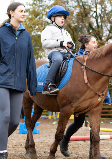 A young person riding a horse.
