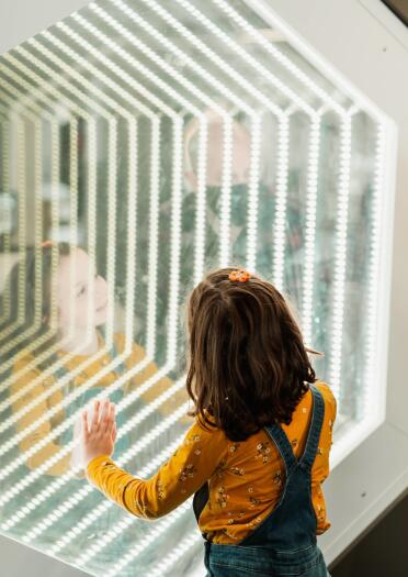 A man and child staring through glass.