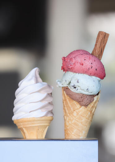 Two ice creams in cones.