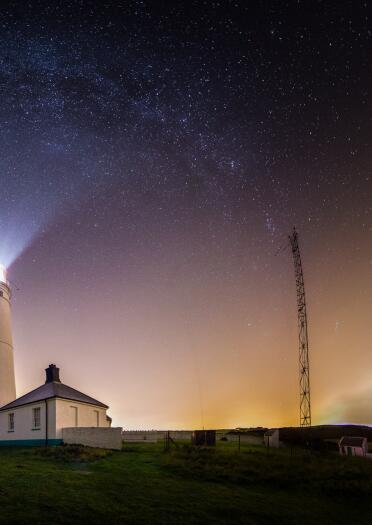 milkway above lighthouse.