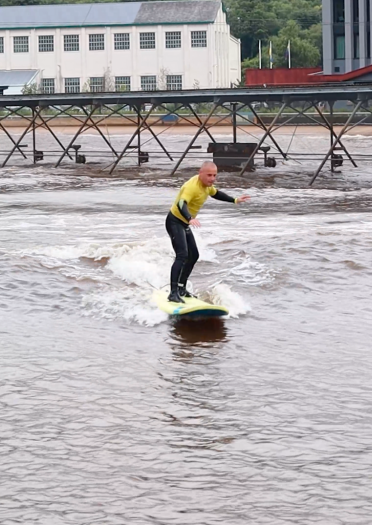 Two people surfing on an inland wave generating lagoon.