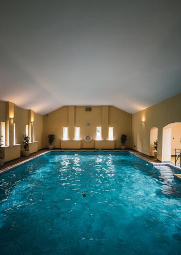 An indoor swimming pool and spa area.