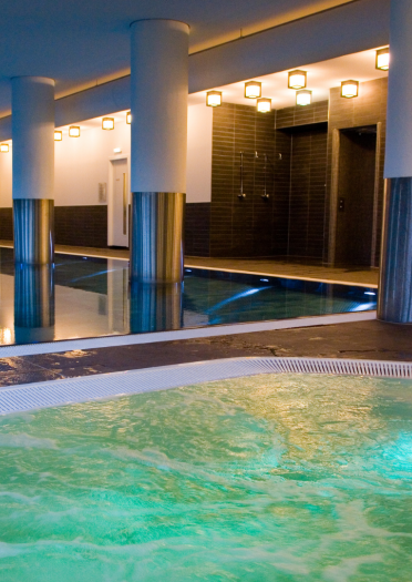 A jacuzzi and swimming pool at an indoor spa.