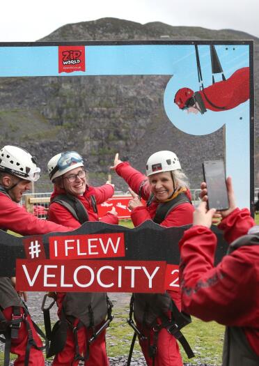 four people taking a selfie at Zip World Velocity.