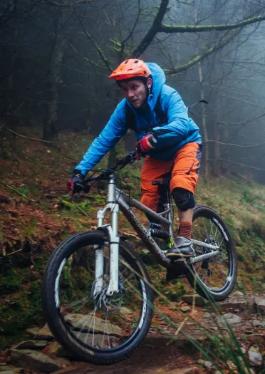 A person on a mountain bike on a rocky downhill trail. 