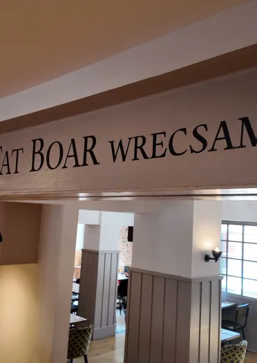 sign The Fat Boar, Wrecam on joist with image of boar underneath.