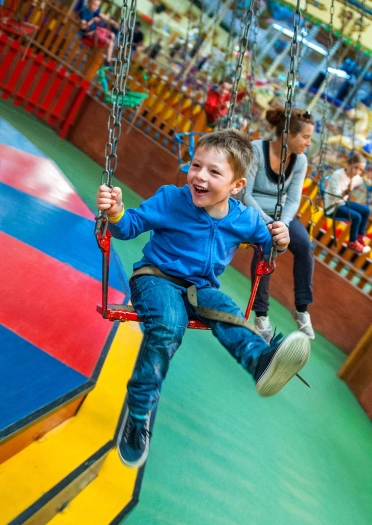 boy on vintage fairground swing.