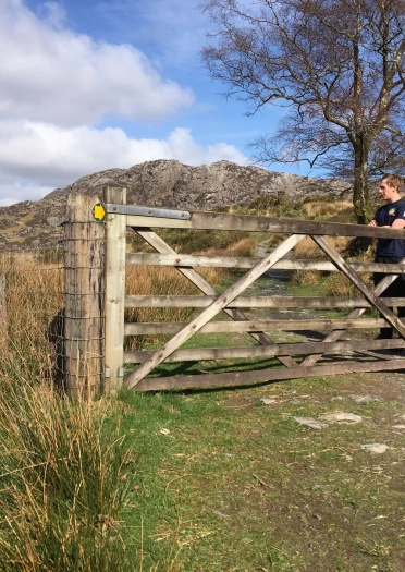 Signpost and gate leading to the Cnicht footpath.