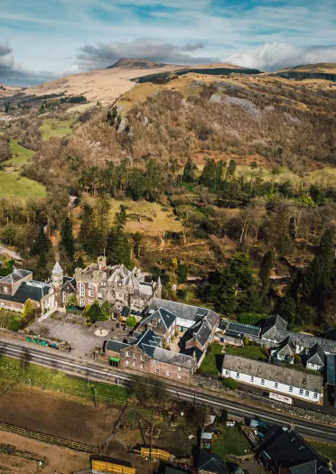 A country house hotel from above, set in beautiful woodlands.