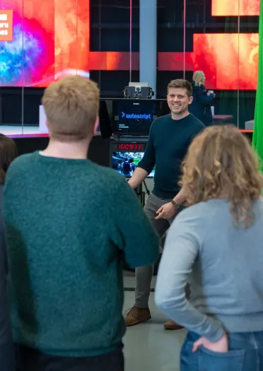 A tour guide explaining something to a group of people. 
