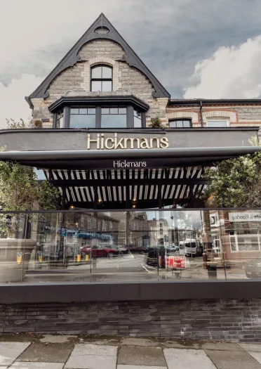 Front exterior of Hickmans restaurant in Penarth with outdoor terrace seating.