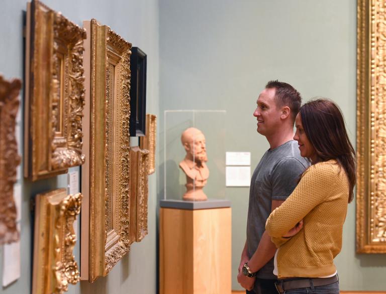 Man and a woman looking at art.