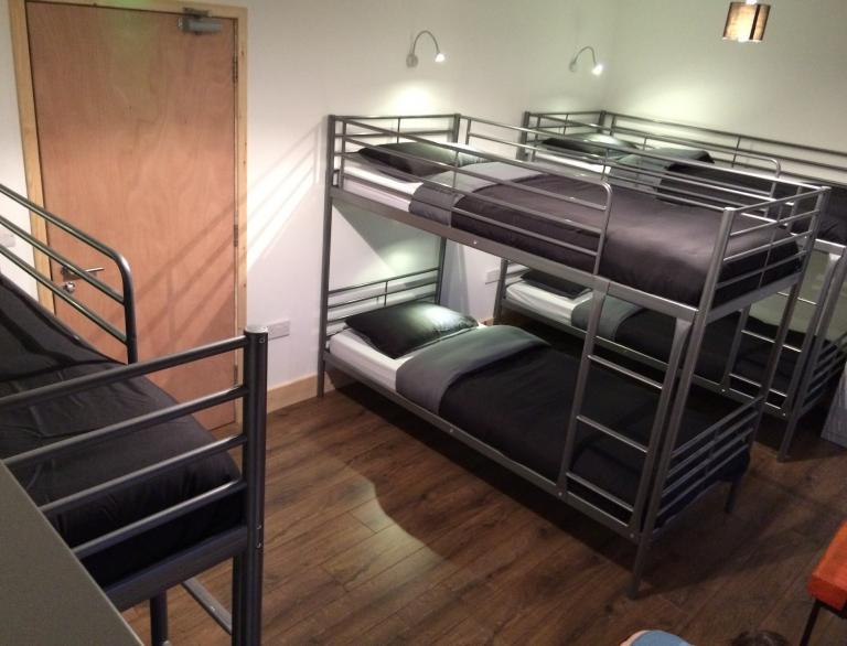 Room with three bunkbeds.