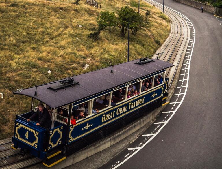 View of the Great Orme Tramway on a steep hill looking down to the sea.