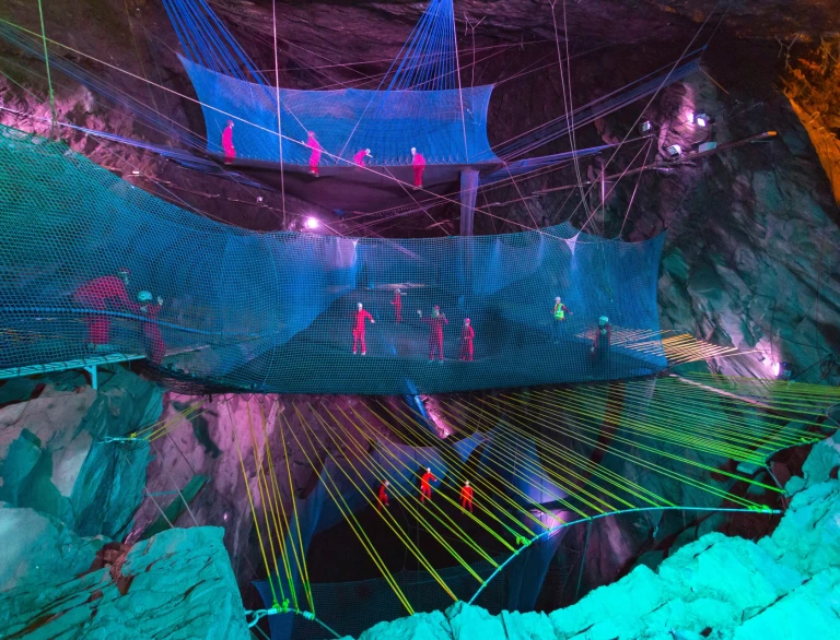People bouncing on underground trampolines.
