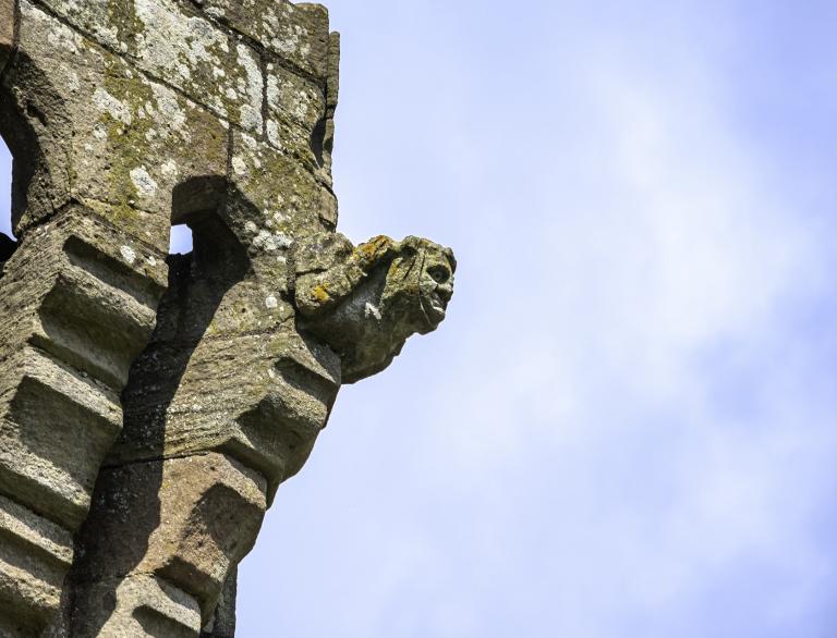 A stone gargoyle on a castle.
